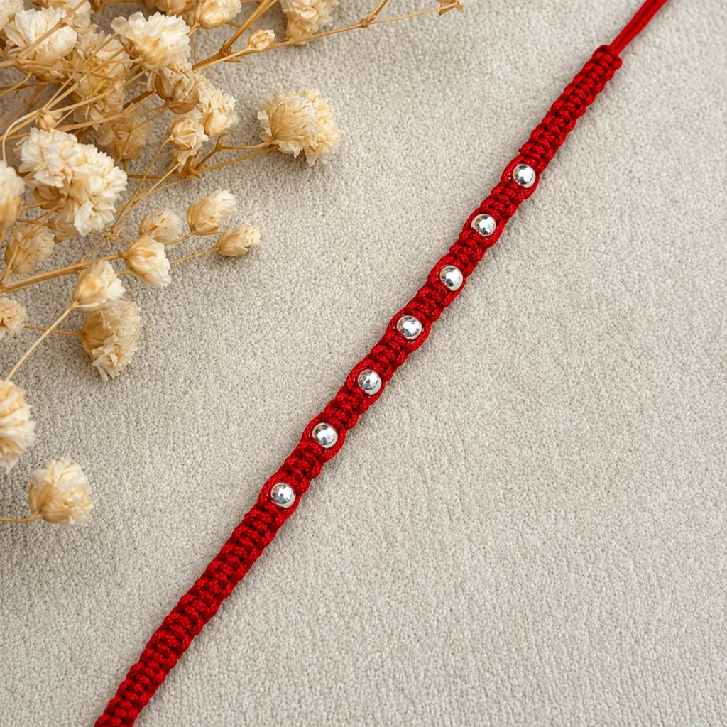 Marvel Silver red thread rakhi for brother with polished silver-tone round bead detailing