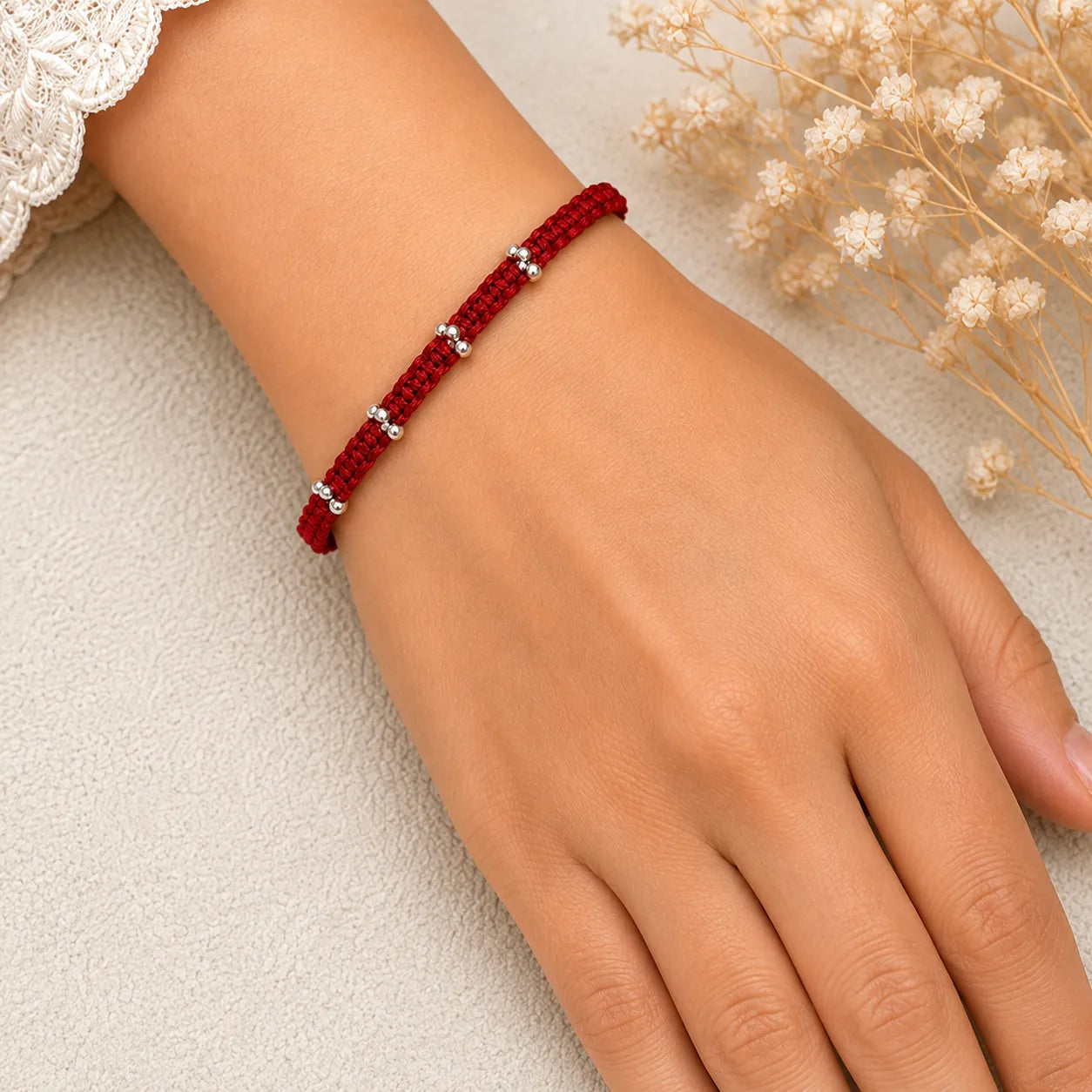 Marvel Silver red thread minimal rakhi with polished silver-tone bead cluster detailing