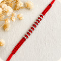 Marvel Silver red thread multi bead rakhi for brother with polished silver-tone bead cluster detailing