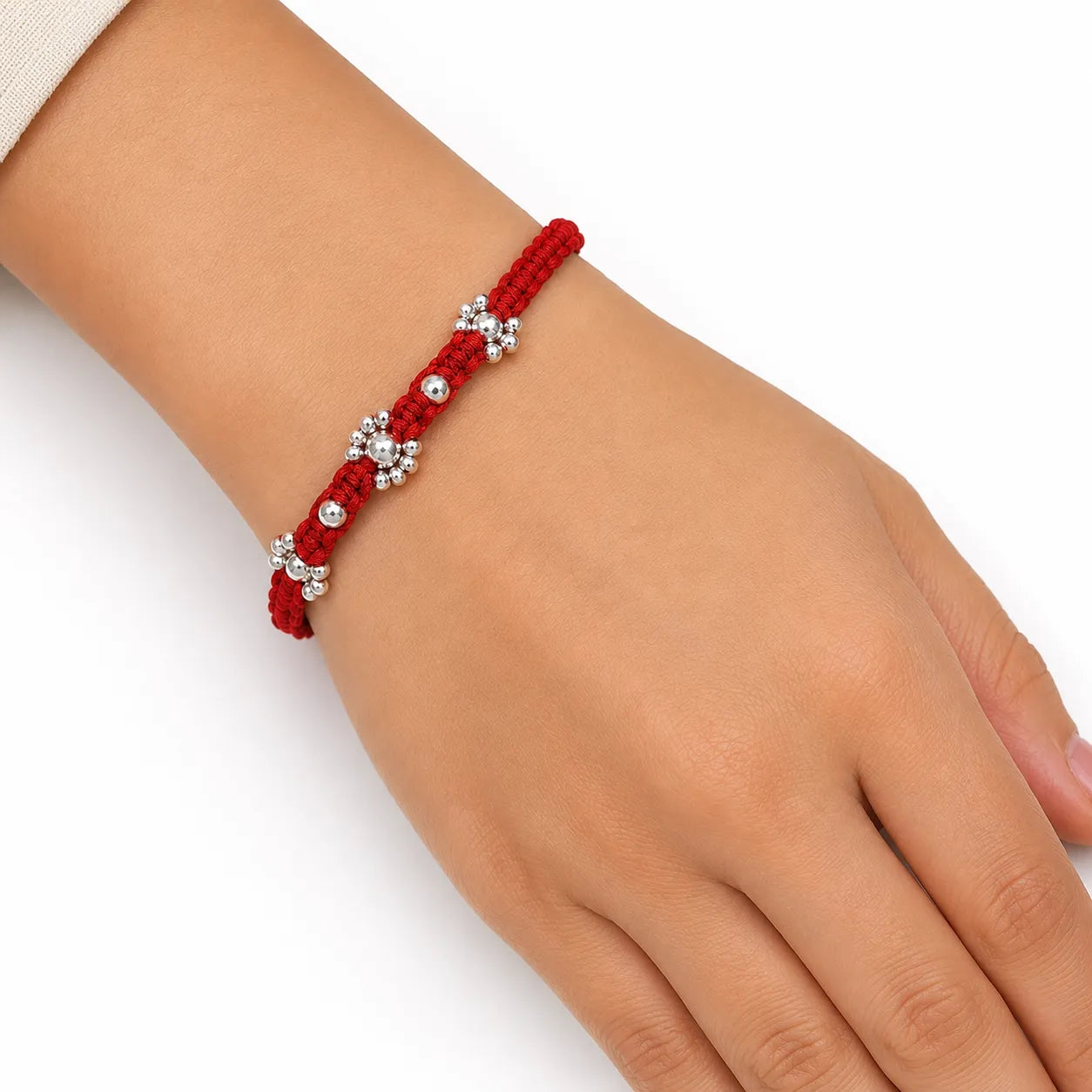 Marvel Silver red thread rakhi with clear stone floral centre and polished silver-tone bead detailing