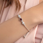 Marvel Silver Ruby Heart Bracelet with adjustable silver chain, ruby red heart crystal, polished silver beads, and sparkling crystal ball accents for women and girls.