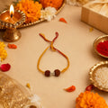 Marvel Silver Rudraksha Bead Designer Rakhi with two natural Rudraksha beads, polished silver spacer, and saffron thread for Raksha Bandhan.