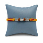 Marvel Silver Rudraksha bead rakhi bracelet for men with yellow red braided thread and silver-tone spacers