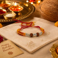 Marvel Silver Rudraksha bead rakhi bracelet for men with yellow red braided thread and silver-tone spacers