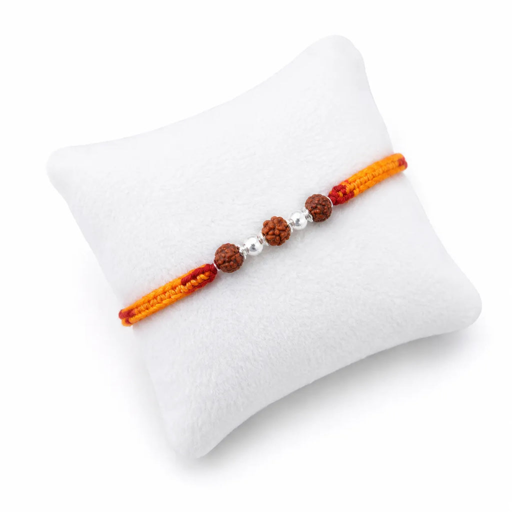 Marvel Silver Rudraksha bead rakhi with polished silver beads on a saffron and red braided thread