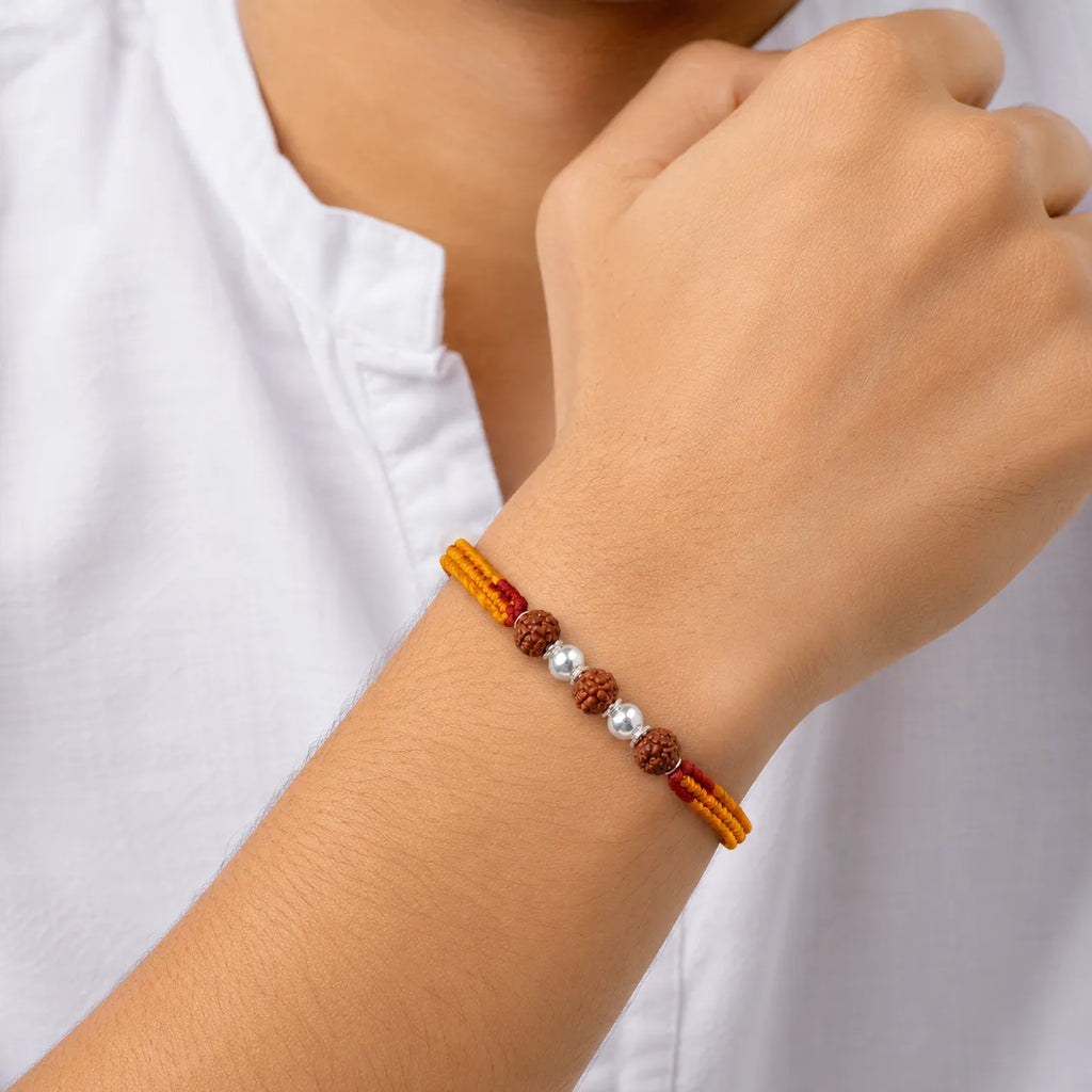Marvel Silver Rudraksha bead rakhi with polished silver beads on a saffron and red braided thread