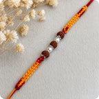 Marvel Silver Rudraksha bead rakhi with polished silver beads on a saffron and red braided thread