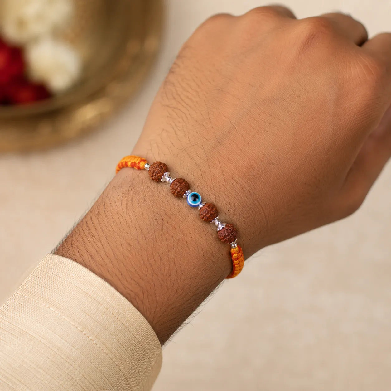 Marvel Silver Rudraksha evil eye rakhi for brother with yellow red braided thread and silver-tone bead accents