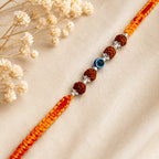 Marvel Silver Rudraksha evil eye rakhi for brother with yellow red braided thread and silver-tone bead accents