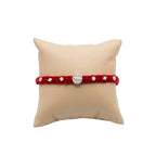 Marvel Silver Satvik Rakhi with spiritual silver-finish centerpiece, handcrafted red thread, and elegant silver embellishments for Raksha Bandhan.