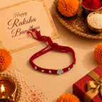 Marvel Silver Satvik Rakhi with spiritual silver-finish centerpiece, handcrafted red thread, and elegant silver embellishments for Raksha Bandhan.