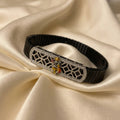 Marvel Silver Shani Dev adjustable bracelet for boys with detailed Shani Dev motif, silver geometric centerpiece and black segmented band