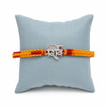 Marvel Silver Shiv name rakhi for brother with yellow red braided thread and silver-tone devotional centre motif