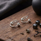 Marvel Silver 925 sterling silver spiral ball earrings featuring a modern open wrap design with polished silver ball accents for women and girls.