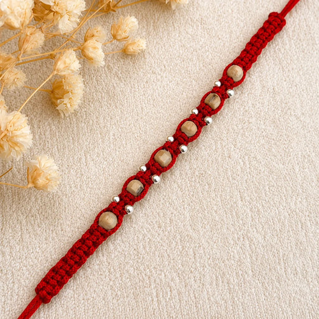 Marvel Silver square bead rakhi for brother with red braided thread, beige square beads and silver-tone accents