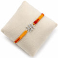 Marvel Silver Swastik design rakhi for brother with yellow red braided thread and stone-studded silver-tone charm