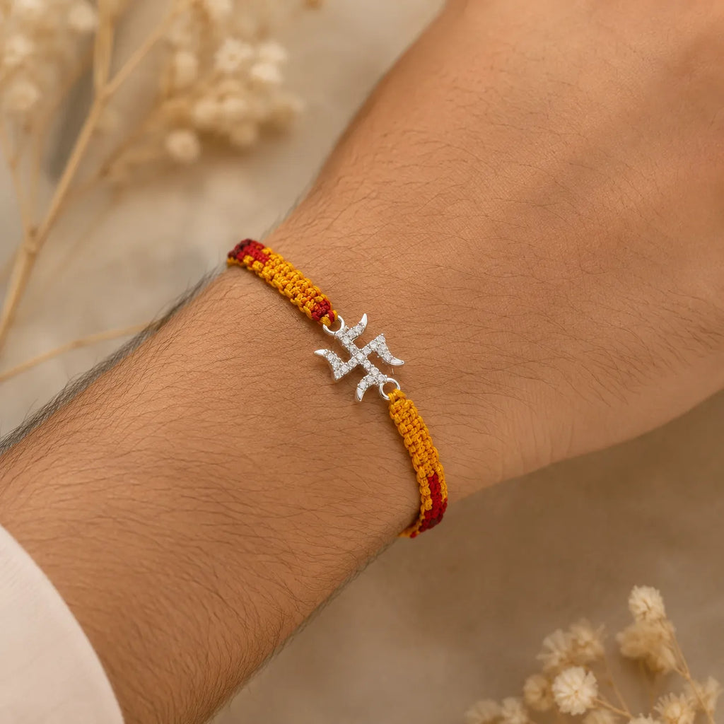Marvel Silver Swastik design rakhi for brother with yellow red braided thread and stone-studded silver-tone charm