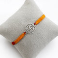 Marvel Silver Swastik motif rakhi for brother with yellow braided thread and silver-tone circular centre charm