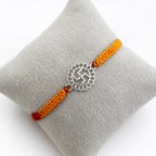 Marvel Silver Swastik motif rakhi for brother with yellow braided thread and silver-tone circular centre charm