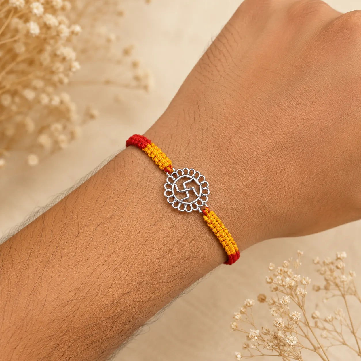 Marvel Silver Swastik motif rakhi for brother with yellow braided thread and silver-tone circular centre charm