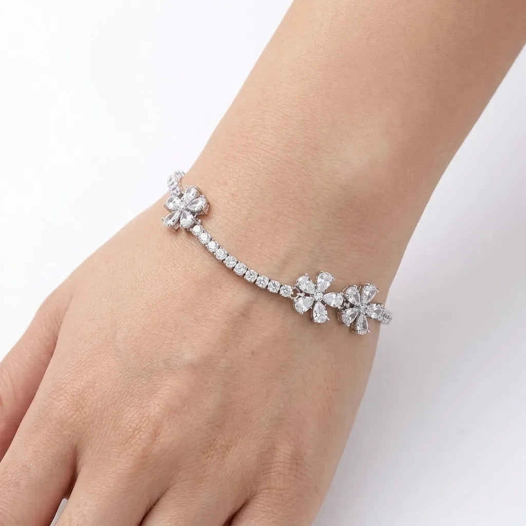 Marvel Silver 925 sterling silver tennis bracelet featuring three sparkling flower motifs with AAA Cubic Zirconia stones, adjustable chain, rhodium-plated finish, elegant bracelet for women and girls suitable for daily wear, parties, weddings, festive occasions, and gifting.