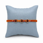 Marvel Silver triple Rudraksha rakhi for brother with red yellow braided thread and silver-tone bead accents