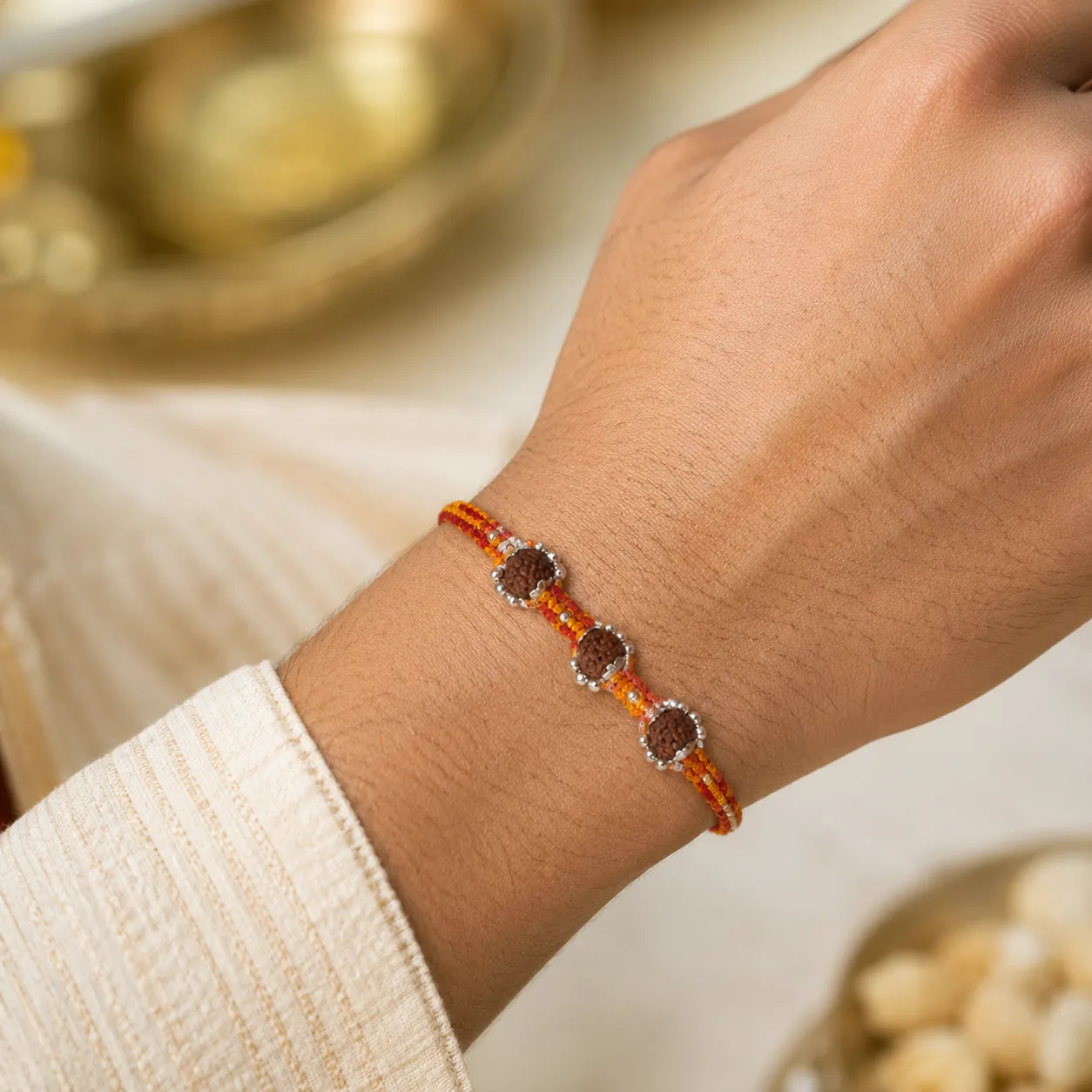 Marvel Silver triple Rudraksha rakhi for brother with red yellow braided thread and silver-tone bead accents