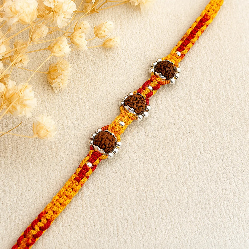 Marvel Silver triple Rudraksha rakhi for brother with red yellow braided thread and silver-tone bead accents