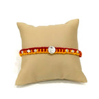 Marvel Silver Veera Rakhi with silver-finish Veera centerpiece, sparkling stone accents, and handcrafted red-yellow thread for Raksha Bandhan.
