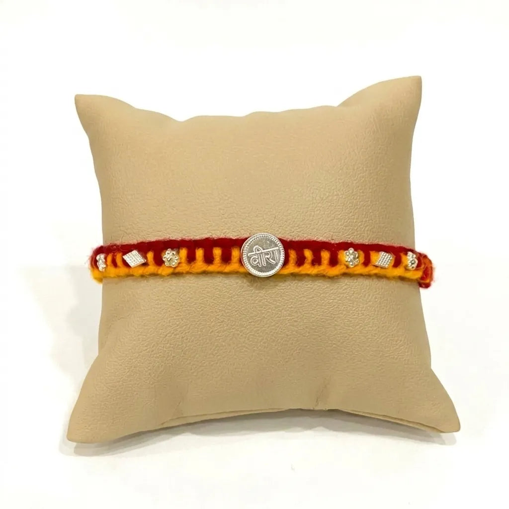 Marvel Silver Veera Rakhi with silver-finish Veera centerpiece, sparkling stone accents, and handcrafted red-yellow thread for Raksha Bandhan.