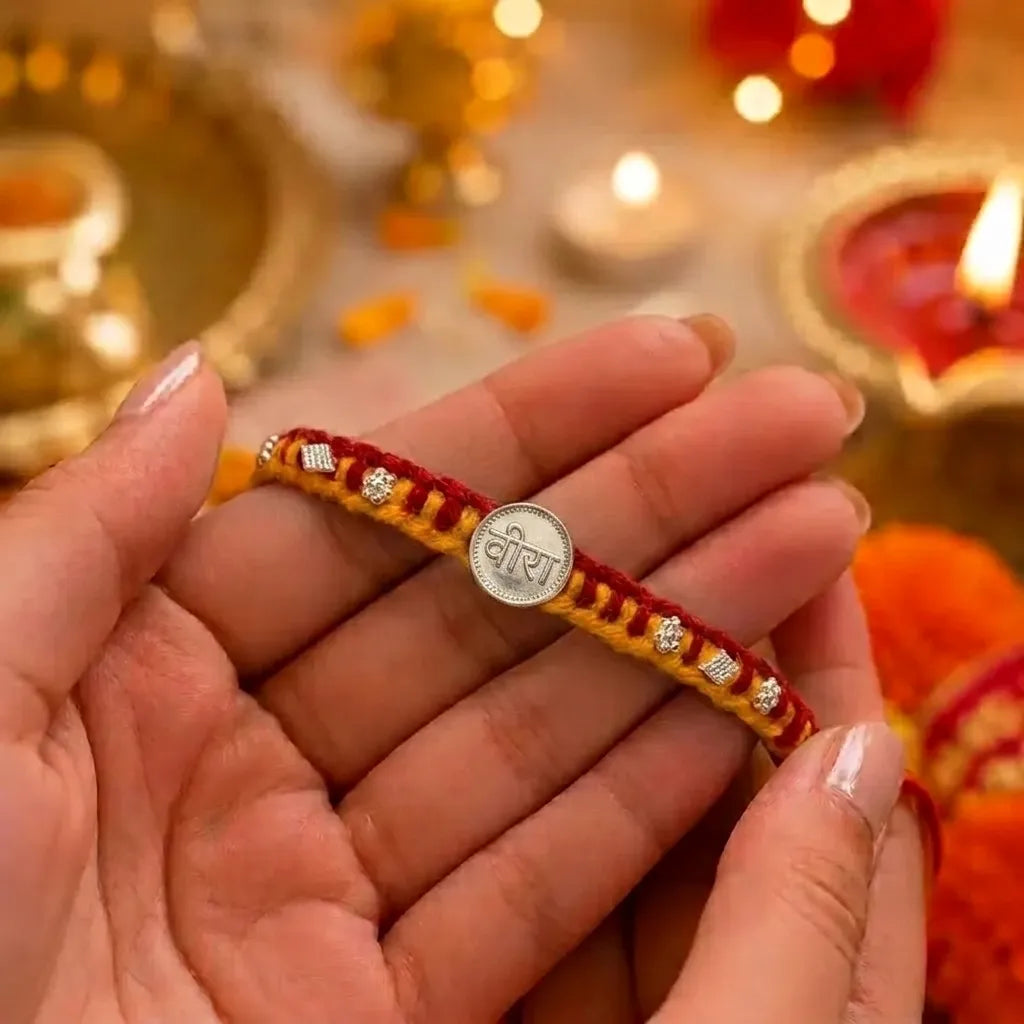 Marvel Silver Veera Rakhi with silver-finish Veera centerpiece, sparkling stone accents, and handcrafted red-yellow thread for Raksha Bandhan.