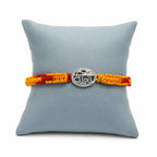 Marvel Silver Veera rakhi for brother with yellow red braided thread and silver-tone name centre motif