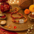 Marvel Silver Veera rakhi for brother with yellow red braided thread and silver-tone name centre motif