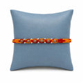 Marvel Silver wooden bead rakhi for brother with red yellow braided thread and silver-tone bead accents