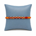Marvel Silver wooden bead rakhi for brother with red yellow braided thread and silver-tone bead accents