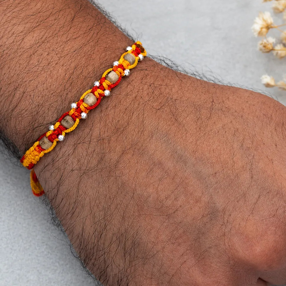 Marvel Silver wooden bead rakhi for brother with red yellow braided thread and silver-tone bead accents