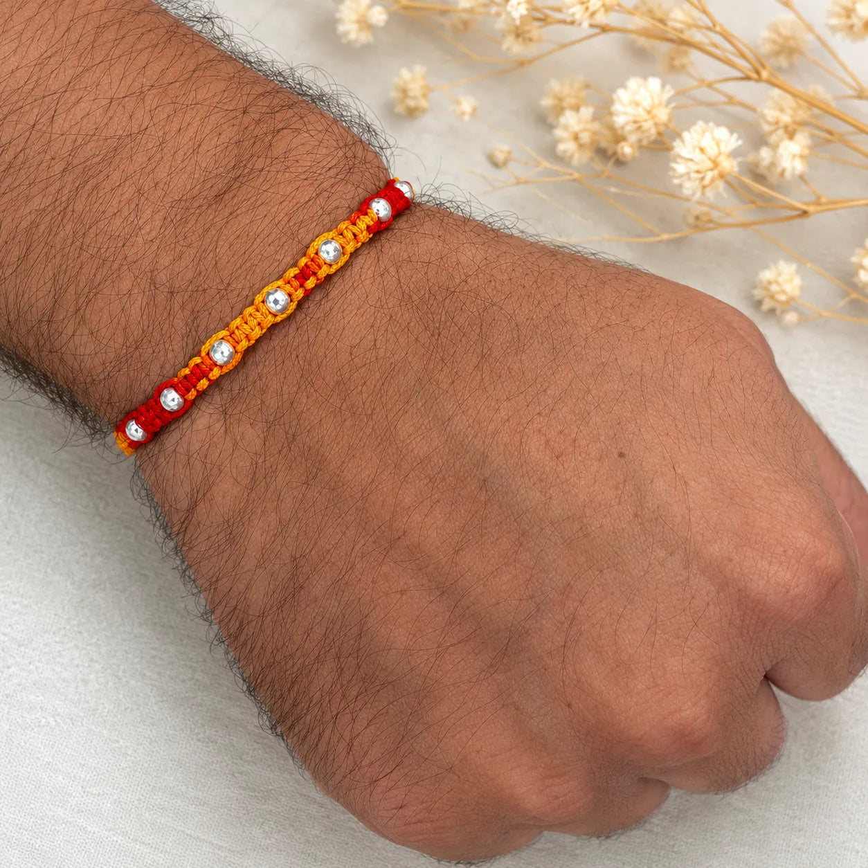 Marvel Silver yellow red bead rakhi for brother with polished silver-tone round bead detailing