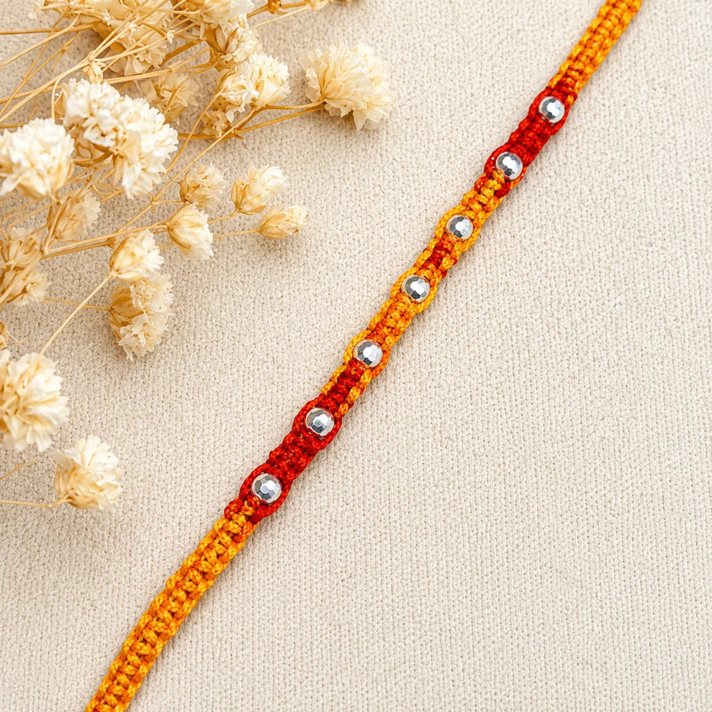 Marvel Silver yellow red bead rakhi for brother with polished silver-tone round bead detailing