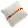 Marvel Silver yellow red bead rakhi for brother with polished silver-tone round bead detailing