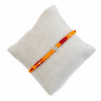 Marvel Silver yellow red floral bead rakhi for brother with polished silver-tone centre bead cluster