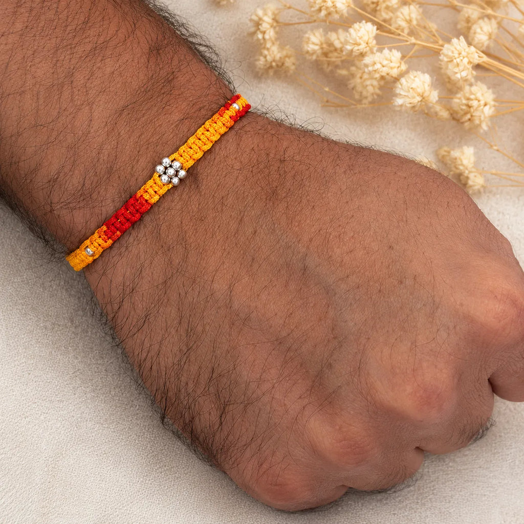 Marvel Silver yellow red floral bead rakhi for brother with polished silver-tone centre bead cluster