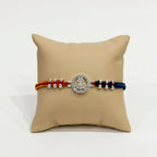 Marvel Silver Shiv Trishul Silver Rakhi with Sacred Red, Saffron and Blue Thread, Silver Beads and Sparkling Shiv Symbol for Raksha Bandhan