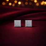•Classic square stud earrings featuring a dense pavé setting of small, brilliant clear crystals.
