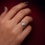 •A delicate silver ring featuring a butterfly design; one wing is a polished open loop, and the other is pavé-set with shimmering crystals.